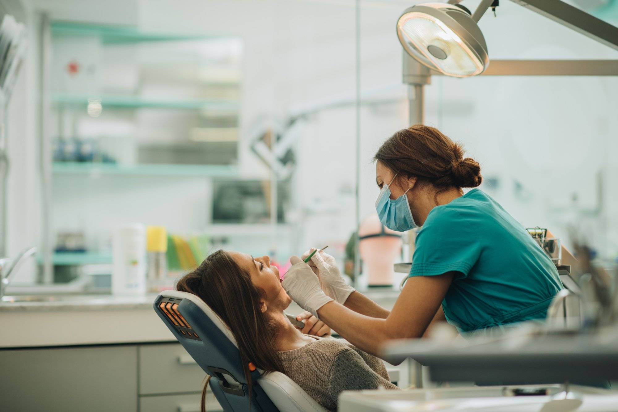 Young woman having her teeth checked during appointment at dentist’s office. Young woman having her teeth checked during appointment at dentist's office.